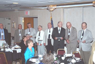 2006 Reunion 75th Anniversary Program Initiation Rite Photo 1
In the three photos a re-initiation ceremony was conducted by Jim Sweet, `56, President, pictured separately.  Most of the nine past presidents in attendance participated in the ceremony, assisted by other members.
 
From the far left of photo 1:  Hal Johnson, `51; Fred Culbert, `65, Past President, 1964-1965, 2nd Sem.; John Schneider, `65, Past President, 1964-1965, 1st Sem.; Norm Arnold, `40; Jim Finnen, `54, Past President, 1953-1954; Howard Lynch, `43, Past President, 1942-1943; Richmond Young, `44; Ken Doran, `39; (just out of view to his left is Ken Haser, `40);
