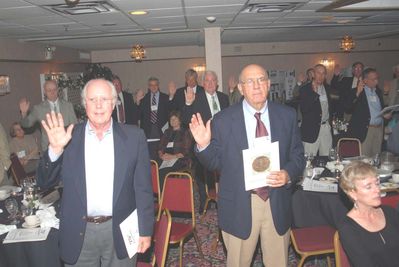 2006 Reunion 75th Anniversary Program Initiation Rite Photo 4
As part of the ceremony, all Pottermen renewed their pledge to uphold the values held by Edward E. Potter, and upon which the Club was founded.

Visible in this photo are Peter Telfer and John Centra in the foreground; Rear from the left: George Wood ; Bob Coan; Don Capuano; Ed Franco; Claude Palczak; honorary member, Dick Sauers; Doug Davis; and George Nigriny.

